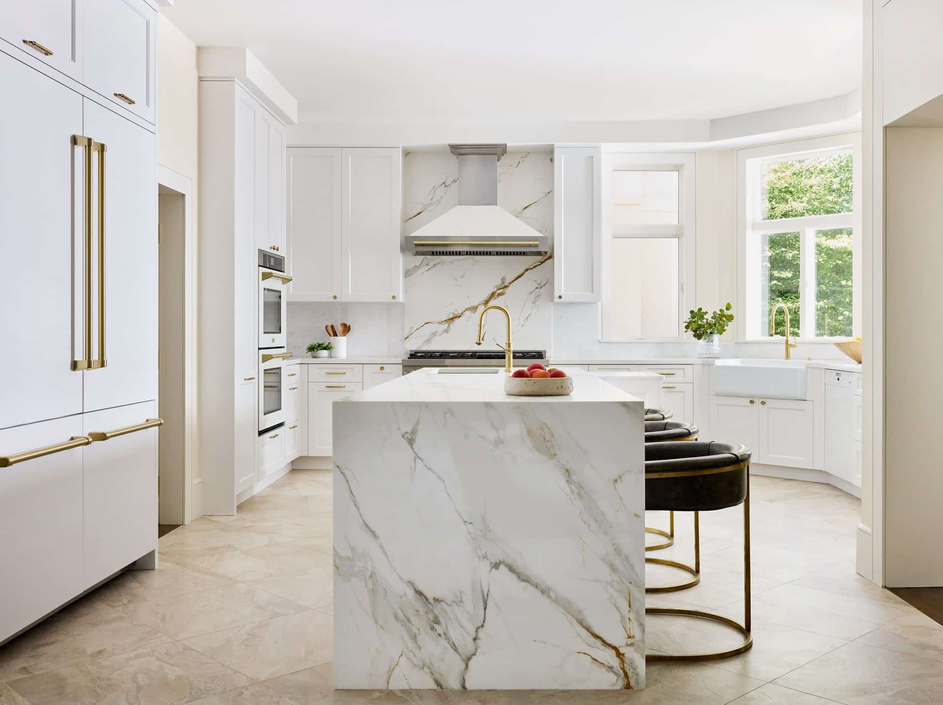 Newton Kitchens - Cutler Road kitchen with marble waterfall island, leather counter stools and paneled refrigerator