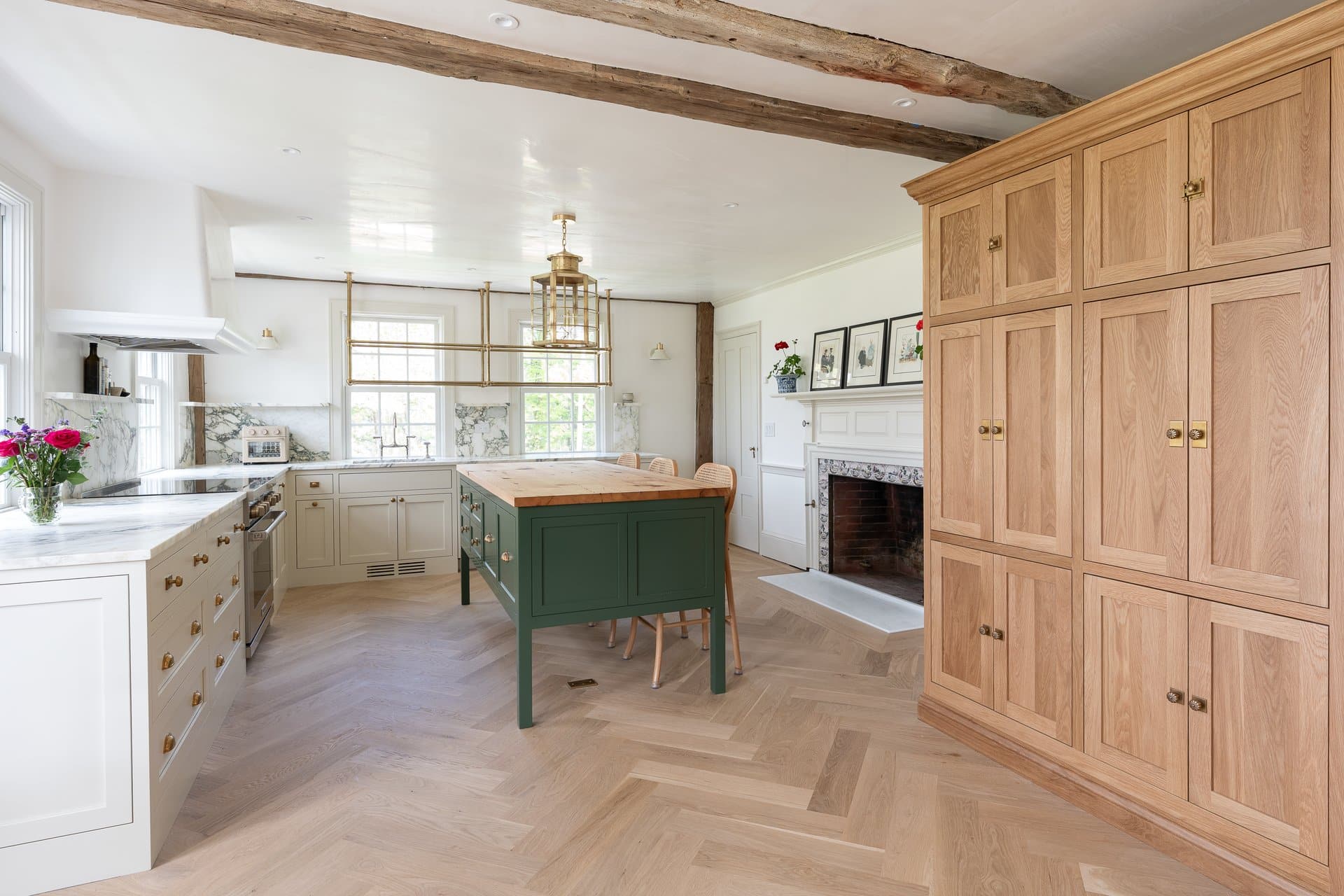 Newton Kitchens - Summer Street kitchen with green island, white oak cabinet wall and herringbone floor