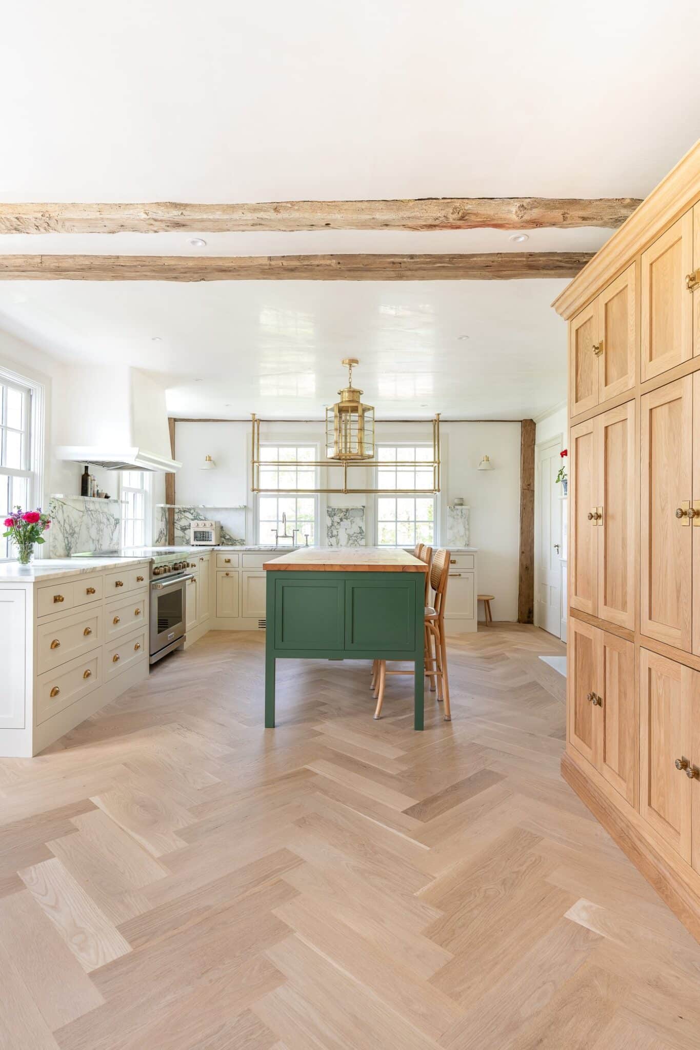 Newton Kitchens - Summer Street kitchen with white oak cabinet wall, green island and exposed beams